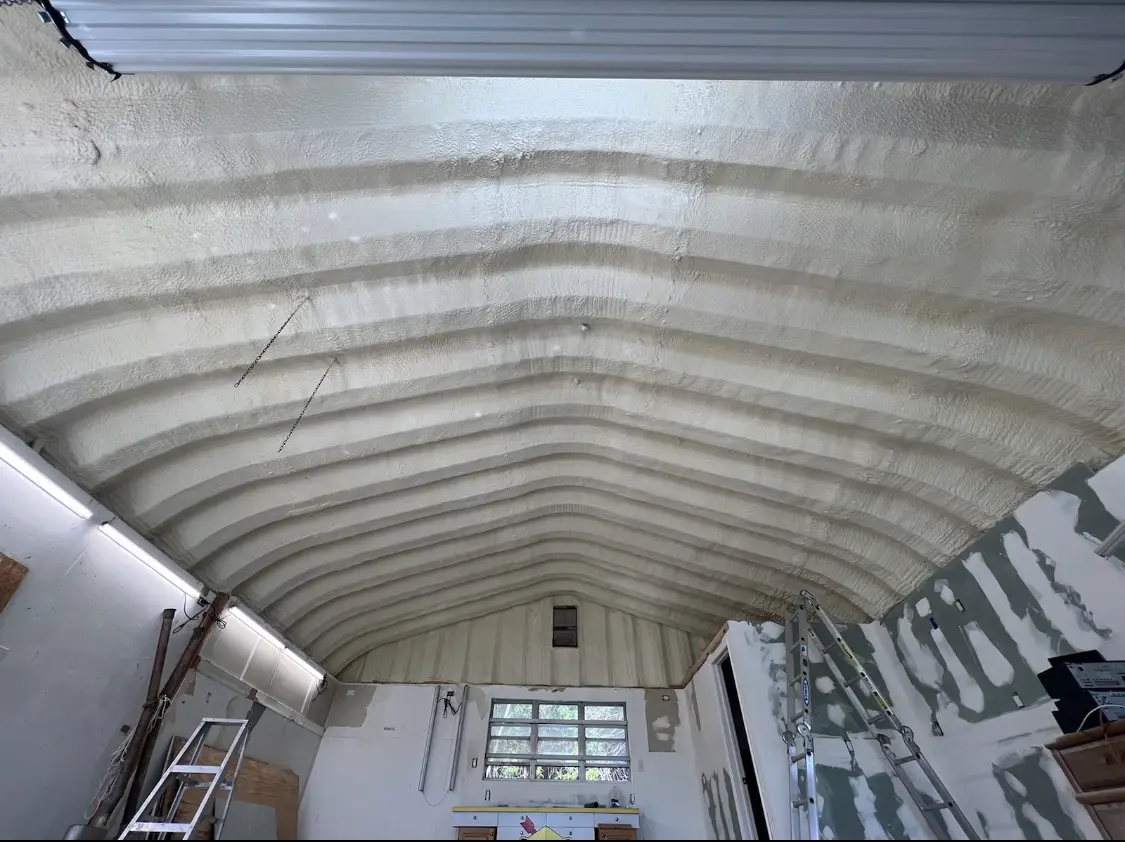 Spray polyurethane foam applied to the underside of a metal roof deck in Gastonia